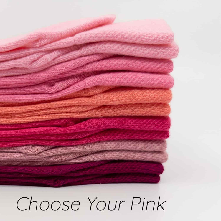 Stack of pink socks with a gradient from light to dark on a white background.